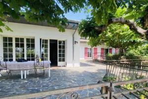 Villa à flanc de colline في سانت-أمبروا: فناء به طاولة وكراسي أمام مبنى