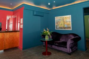 a living room with a purple chair and a table at Skeffington Arms Hotel in Galway