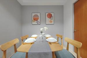 a dining room table with chairs and a tablecloth on it at Pavilion Bukit jalil Walking Distance 2 Bedroom 2-4Pax in Kuala Lumpur