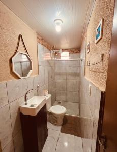 a bathroom with a toilet and a sink at Martinelli Residence in Fernando de Noronha