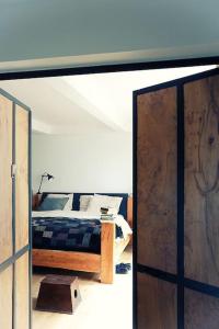 a bedroom with a bed and a large mirror at Très beau Loft Industriel Paris 20e in Paris