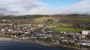 an aerial view of a town next to the water at Thistle Apartment in Golspie