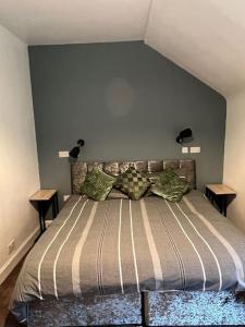 a bedroom with a bed with two night stands at The Mews Holiday Let in Tillicoultry