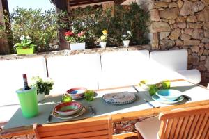 a table with plates and utensils on it at Residence Ira Beach - Appartamento sul mare in Porto Rotondo