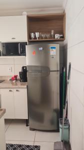 a kitchen with a stainless steel refrigerator in a kitchen at Apartament litoral norte Natal RN in Natal