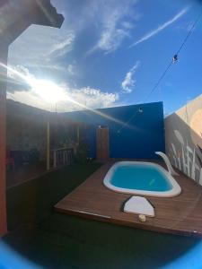 a bathroom with a jacuzzi tub on a patio at Casa com piscina aconchegante in Ribeirão Preto