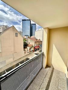 a balcony with a view of a city at Elegant apartment Paris Bagnolet 303 in Bagnolet
