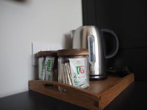 a wooden shelf with a coffee pot on it at The Pavilion Bisley in Bisley