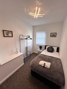 a bedroom with a bed and a bath tub at Cathedral Walk 3 Bed Coachhouse in Lichfield