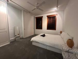 a white bedroom with a bed and a window at Remarkable 2 Bedroom House at the Centre of Darlinghurst in Sydney