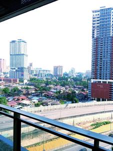 a view of a city from the balcony of a building at Summer Service Suite Klcc By CityBox in Kuala Lumpur