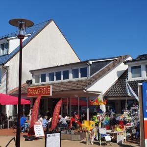 Ein Markt mit Menschen, die vor einem Gebäude sitzen in der Unterkunft Haus Itjen Blau 4 in Cuxhaven