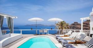 a villa with a pool and a view of the ocean at Mill Houses New Elegant Suites in Firostefani