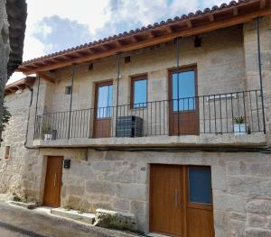 an old stone house with a balcony at Casa MENDEZ - ALLARIZ in Ourense