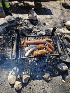 a bunch of hot dogs cooking on a grill at Emmental Ferien in Langnau im Emmental