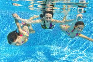 a group of children swimming in a swimming pool at Lovely 8 Berth Caravan With Decking At Sunnydale Park, Lincolnshire Ref 35091br in Louth