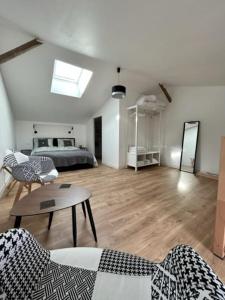 a living room with a bed and a table at The blue lotus gite and spa in Le Langon