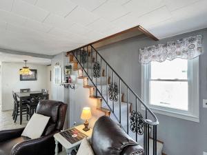 a living room with a staircase and a table at Sweet Dreams W032 Brought to you by GetAway Vacations in Wells
