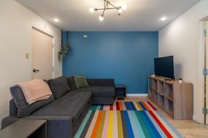 a living room with a couch and a flat screen tv at Urban Nest, 1-BDRM Apt, Ground Floor in Halifax