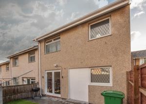 a brick house with a white garage door at Modern House w/Terrace in Nottingham FREE Parking in Nottingham