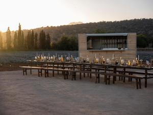 a long wooden table with bottles and glasses at The Lodge Mallorca, Small Luxury Hotels in Sa Pobla +52 photos