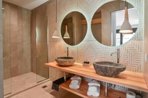 a bathroom with a sink and a mirror at Acacia - Explore your senses in Preveza