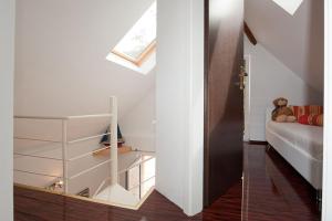 a white room with a bed and a teddy bear at Chalet Stahl - Ferienhaus mit Pool in Freiburg im Breisgau +17 photos