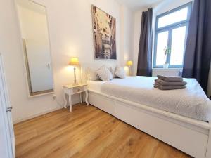 una camera bianca con un grande letto con finestra di 2 room apt. near station Neustadt in It district a Dresda