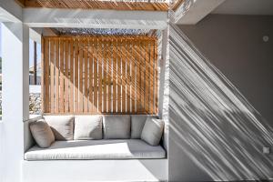 a couch sitting in front of a window at Acacia - Explore your senses in Preveza