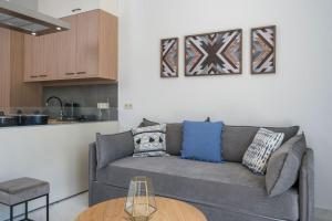a living room with a couch and a table at Kyma beach - Apollon apartment - 2ad & 2kids in Kolymvari