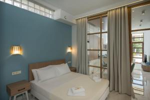 a small bedroom with a bed and a window at Kyma beach - Apollon apartment - 2ad & 2kids in Kolymvari