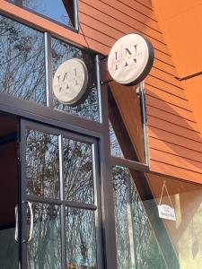 two clocks on the side of a building with windows at Infinite Resort and Cafe in Krabi town