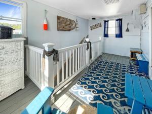 a room with a staircase with blue chairs and a rug at Sweet Serenity - Y846 condo in York