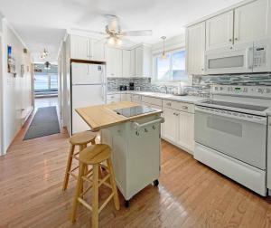 a kitchen with white appliances and a wooden floor at Sweet Serenity - Y846 condo in York