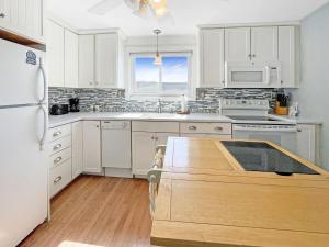 a kitchen with white cabinets and a white refrigerator at Sweet Serenity - Y846 condo in York