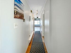 a hallway with white walls and a black floor at Sweet Serenity - Y846 Brought to you by GetAway Vacations in York +16 photos