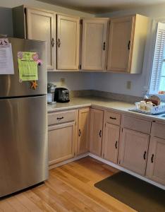 a kitchen with wooden cabinets and a stainless steel refrigerator at Family Retreat at York Beach Y609 home in York