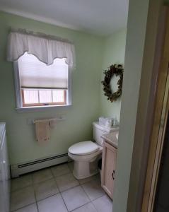 a bathroom with a toilet and a window at Family Retreat at York Beach Y609 home in York