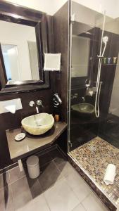 a bathroom with a sink and a shower at Villahotel Rheinblick in Cologne