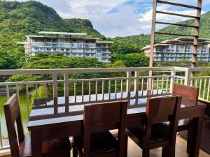 a table and chairs on a balcony with a view at Miranda 514B 2br at Pico de Loro by Raquel's Place in Nasugbu