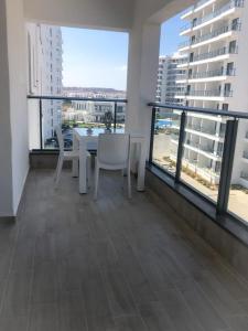 a balcony with a table and chairs in a building at Caesar Blue Resort & Spa 1+1 in Kalecik