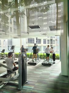a group of people exercising on treadmills in a gym at Summer Service Suite Klcc By CityBox in Kuala Lumpur