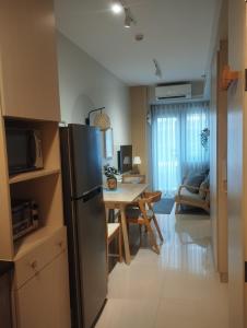 a kitchen and dining room with a refrigerator and a table at S Residences in Manila