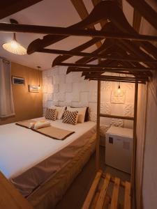 a bedroom with a bed with a wooden bed frame at Martinelli Residence in Fernando de Noronha