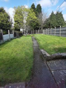 a path in a yard next to a fence at Toro's place in Sedgley