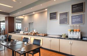 a restaurant with two tables and a counter at Fairfield by Marriott Bogota Embajada in Bogotá