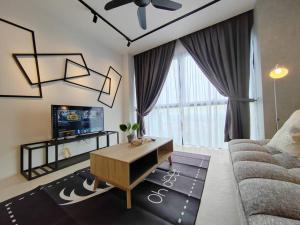 a living room with a couch and a tv at Lumi Tropicana 3 Bedroom Golf View # 1-6pax in Petaling Jaya