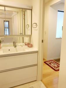 a bathroom with a sink and a large mirror at Tokyo Center Ikebukuro Family villa quiet 4BR group stay & parking near JR in Tokyo +18 photos