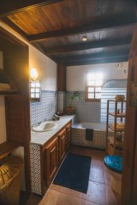 a bathroom with a sink and a bath tub at Casa Muna in El Cercado