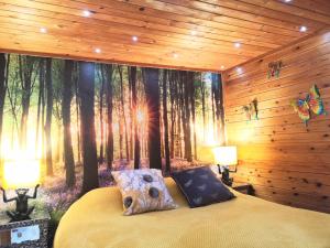 a bedroom with a forest mural on the wall at Otter 1 HuntersMoon-Warminster-Longleat-Wiltshire in Warminster